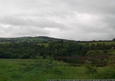 The old railway bridge over the Mourne River seen from the A5 ©Eric Jones The old railway bridge over the Mourne River seen from the A5