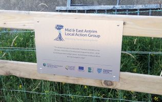 A sign describing the funding for the Glenravel Greenway