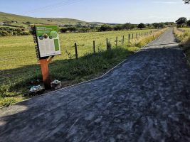 A view along the Glenravel Greenway with an information sign